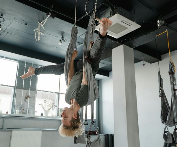 Man holding a challenging yoga balance pose, showing strength and focus.